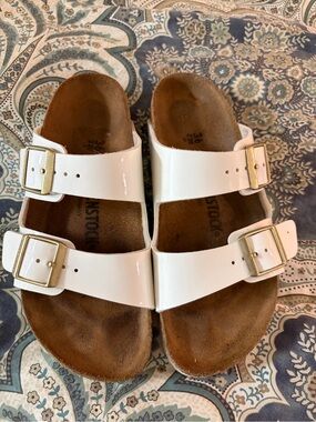 Birkenstock Arizona White Two-Strap Sandals with Gold Buckles